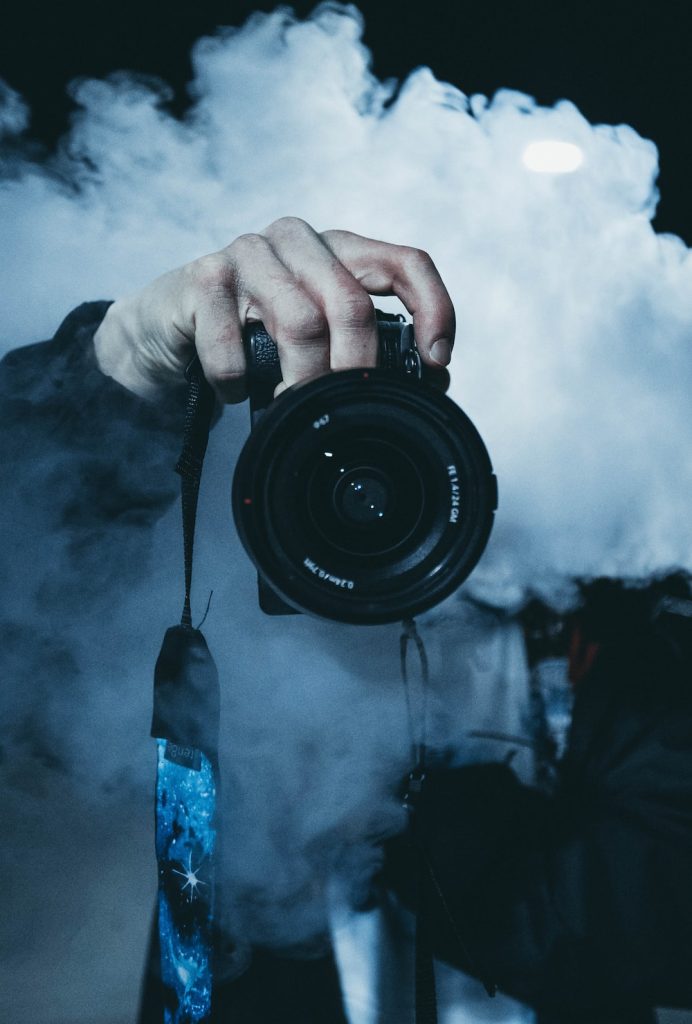 Camera lense surrounded by smoke
